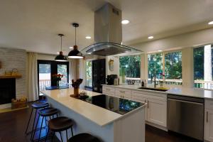 a large kitchen with a large island with bar stools at Lake House - Anderson Island in Anderson Island
