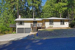 a house with a porch and a garage at Lake House - Anderson Island in Anderson Island