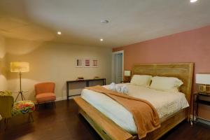 a bedroom with a large bed and a chair at Lake House - Anderson Island in Anderson Island