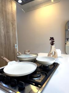 two frying pans sitting on top of a stove at Loft Americana Chapultepec Alberca Wifi AC in Guadalajara +19 photos