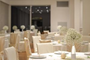 a dining room with white tables and white chairs at Tramonto d'Oro in Praiano +179 photos