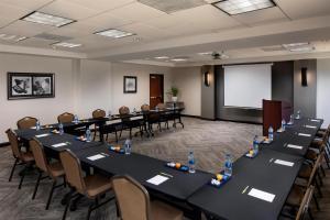 a conference room with tables and chairs and a whiteboard at Hyatt Place Dallas Park Central in Dallas +48 photos