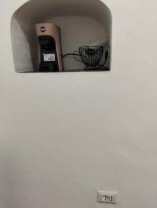 a pay phone sitting on top of a wall at B&B Scotto in Procida