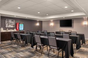 a conference room with black tables and chairs and a screen at Homewood Suites by Hilton Columbus/Polaris in Columbus +32 photos