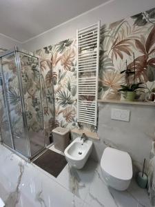 een badkamer met een douche, een toilet en een wastafel bij La Casa di MBAPE in Meda