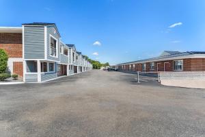 an empty parking lot next to a row of buildings at Econo Lodge Cranston - Providence in Cranston