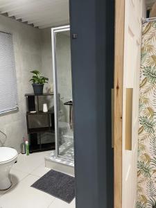 a bathroom with a toilet and a glass shower at AtTheDeck in Pietermaritzburg +55 photos