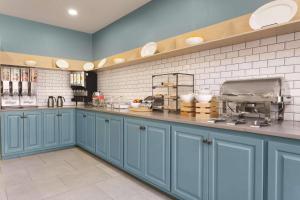 a kitchen with blue cabinets and a counter top at Country Inn & Suites by Radisson, Valparaiso, IN in Valparaiso