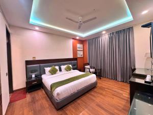 a bedroom with a large bed in a room at Amber Inn by Orion Hotels in New Delhi