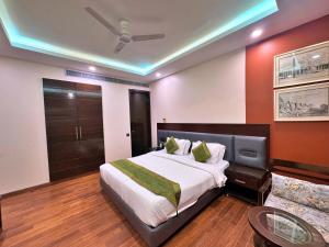 a bedroom with a large bed and a table at Amber Inn by Orion Hotels in New Delhi