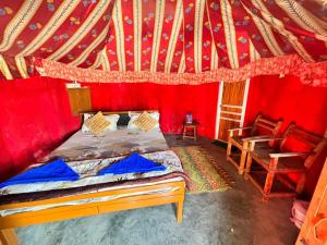 a bedroom with a bed in a red room at Gangaram osian village home stay in Osiān