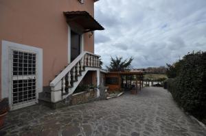 a building with a staircase on the side of it at Casale De Santis in Rome