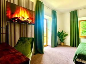 a living room with a fireplace and green curtains at Hotel Bergen Zur Post by Rikas Hotels in Bergen