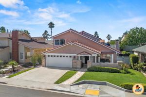 a house with a driveway and a garage at Cozy Tierrasanta Escape-4BR, Pool, Firepit, Games! in San Diego