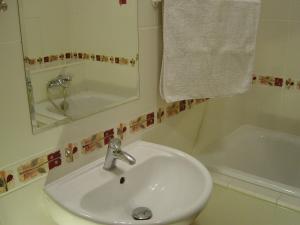 a bathroom with a sink and a mirror and a tub at Bogusławskiego 18 in Warsaw +9 photos