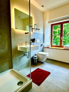 a bathroom with a shower and a sink and a toilet at Hotel Bergen Zur Post by Rikas Hotels in Bergen
