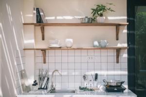 a kitchen with a sink and shelves above it at The Jade Phoenix Hanoi-Cozy Retreat with Private Balcony-Free Laundry in Hanoi +163 photos