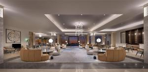 a lobby with chairs and tables in a building at Kempinski Hotel & Resort Sariya Yanbu Red Sea in Yanbu