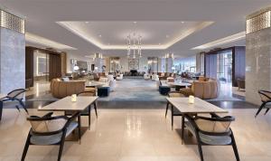 a restaurant with tables and chairs and a lobby at Kempinski Hotel & Resort Sariya Yanbu Red Sea in Yanbu
