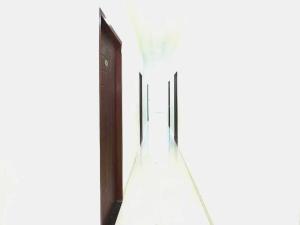a hallway with a glass floor and a wooden door at OYO 91941 Hotel golden crown in Sirhind