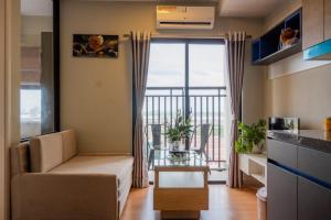 a living room with a couch and a balcony at PhnomPenh Apartment by The Star Polaris 23 Condo in Phnom Penh