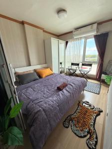 a bedroom with a bed with a leopard rug on the floor at SHaCk Place 87 in Ban Puk (2)