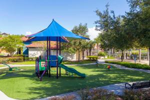 a playground with a slide in a park at Luxury 12BR Home w Pool Theater Game Room in Kissimmee