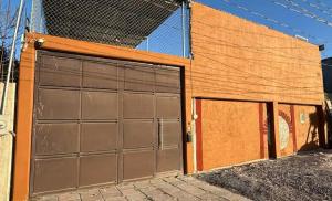 two garage doors on the side of a building at Espacio Encantador in San Pedro Atzompa