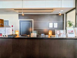 a bar with lights on top of a counter at Sakura Hotel Oami in Ōami