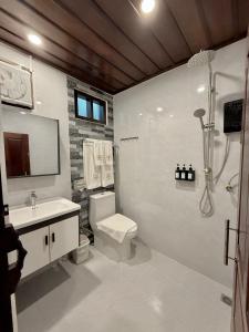 a bathroom with a toilet and a sink and a shower at Onson De Boutique Hotel in Luang Prabang +40 photos