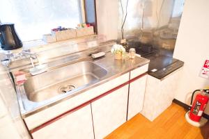 a kitchen with a stainless steel sink in it at ZENNOOK riverside Fuji in Shizuoka +42 photos