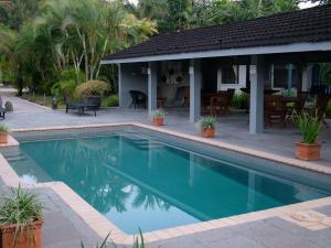 a swimming pool in front of a house at Pacific Lagoon Apartments in Port Vila