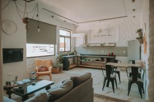 a living room with a couch and a table at mandala central apartment in Rhodes Town