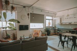 a living room with a couch and a table at mandala central apartment in Rhodes Town
