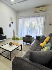 a living room with a couch and a table at BBF Cozy Hub in Kamunting