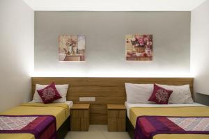 Postel nebo postele na pokoji v ubytování Lavana Hotel Batu Caves + 32 fotografií