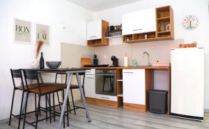a kitchen with a table and a refrigerator at Villa Volk in Ilirska Bistrica