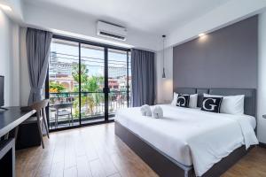 a bedroom with a large bed and a balcony at Z8 beach hotel in Jomtien Beach +45 photos