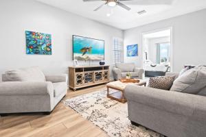 a living room with two couches and a tv at 108 Mediterranean Way in Indian Harbour Beach