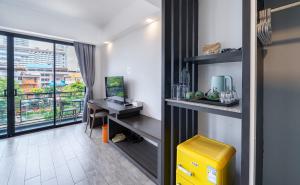 a room with a desk and a table with a window at Z8 beach hotel in Jomtien Beach