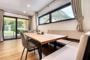 a dining room with a table and chairs and large windows at bsundrix Tiny Homes in Bludenz +26 photos