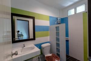 a bathroom with a sink and a toilet and a mirror at The Target Hotel chaingrai in Chiang Rai +111 photos