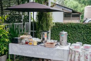 a table with food on it with an umbrella at The Target Hotel chaingrai in Chiang Rai