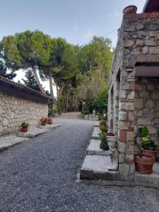 an empty street next to a stone building at Casale Nadia in Sarteano +8 photos