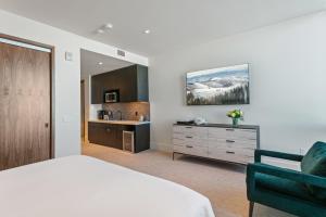a bedroom with a bed and a bathroom with a sink at Argent at Deer Valley Resort - Hotel Room #105B Hotel Room in Park City