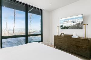 a bedroom with a large bed and large windows at Argent at Deer Valley Resort - Hotel Room #105A Hotel Room in Park City