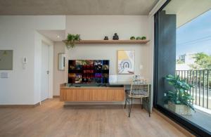 a living room with a counter and a chair at Dark - Hassler - 105 - Jose Canese in Asuncion