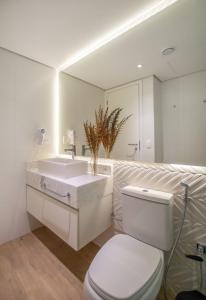 a bathroom with a white sink and a toilet at Dark - Hassler - 105 - Jose Canese in Asuncion