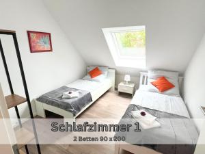 a small room with two beds and a window at Ferienwohnung "Atlantis" Papenburg Balkon Einbauküche Neubau 74 qm Free Wifi 2 Schlafzimmer 4 Personen in Papenburg