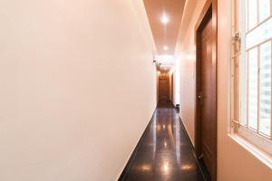 a hallway with a long corridor with a window at Collection O Paschim Dwar Near Jagannath Temple Formerly Hotel Subhadarshan in Puri